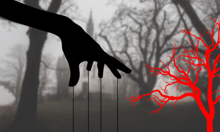 hand with marionette strings dangling reaching for red branch with fog covered church in background